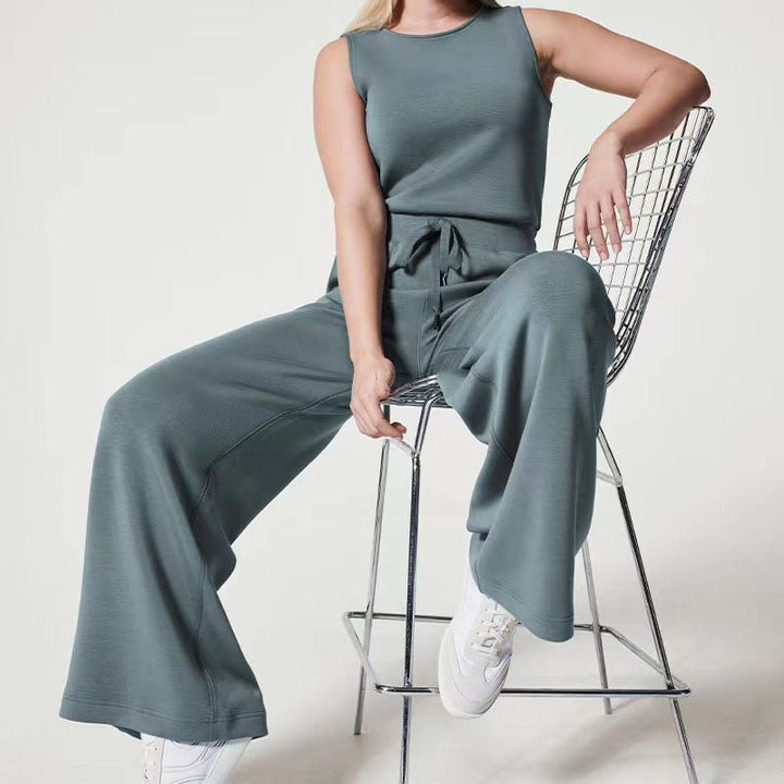 Elegant women’s jumpsuit displayed on a plain background with a smooth draped fit.
