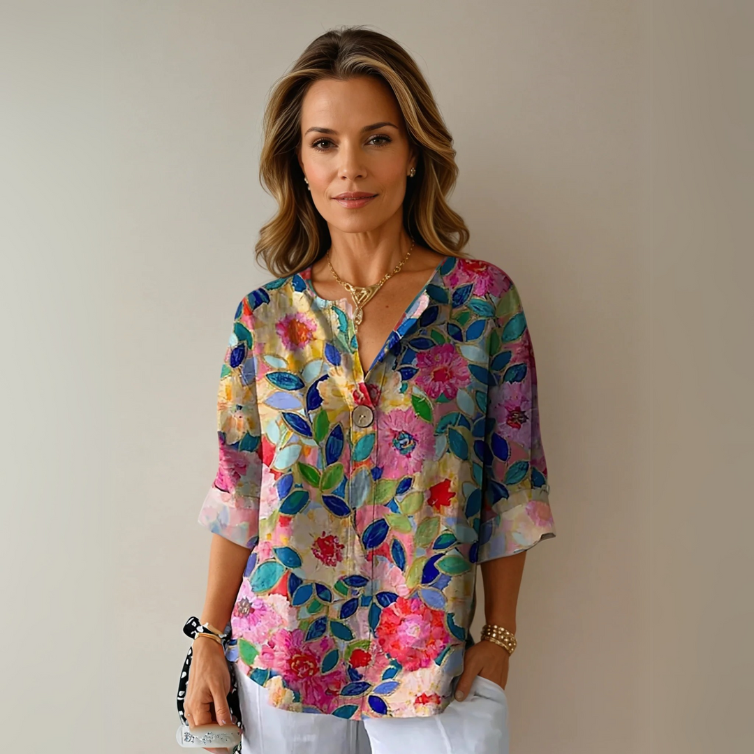 Floral blouse with model on a plain background, styled for everyday wear.