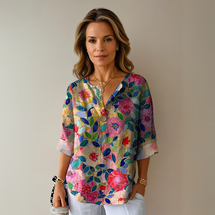 Floral blouse with model on a plain background, styled for everyday wear.