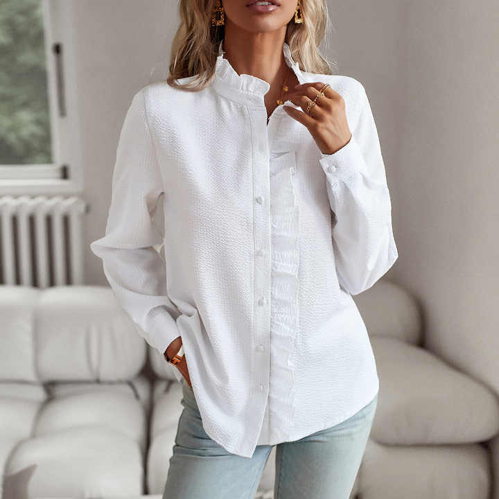 Relaxed daily wear top with gentle front draping on a model against a plain background.