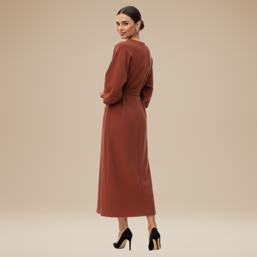 Woman in a feminine midi dress with draped wrap styling on a plain background.