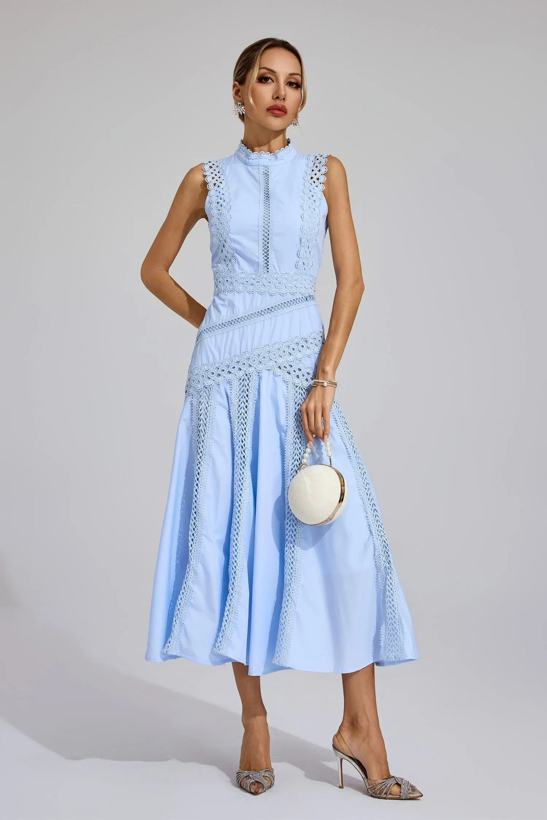 Female showcasing a sleeveless occasion dress with a defined