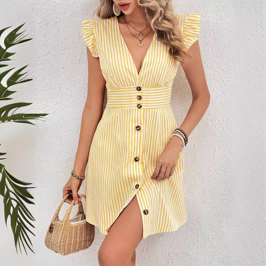 Woman wearing a V-neck A-line dress with ruffle cap sleeves on a plain background.