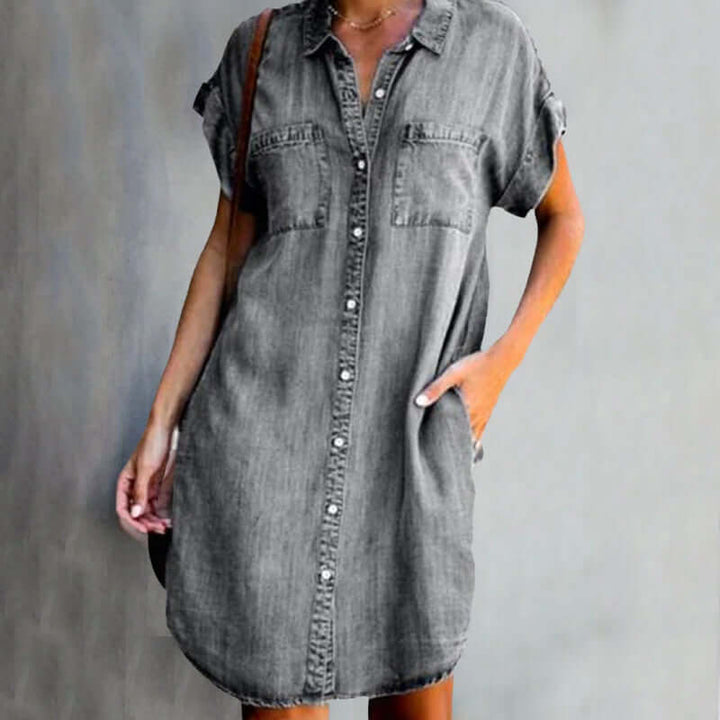 Female wearing a casual denim shirt dress on a clean background.