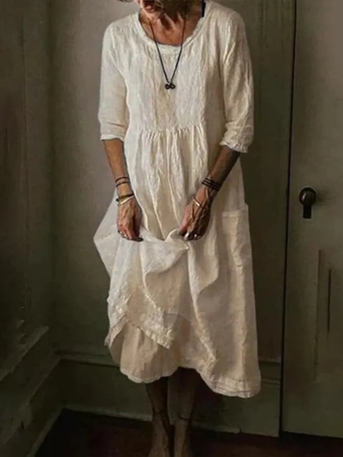 Woman styled in a casual loose fit midi dress on a clean background.