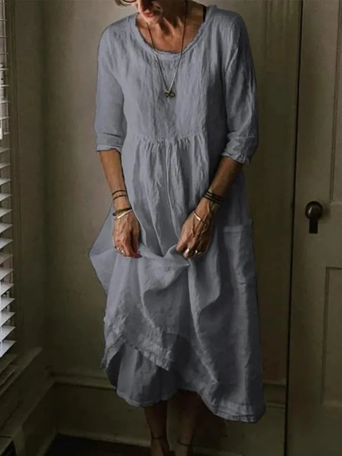 Model wearing a comfortable midi dress with round neck on a plain background.