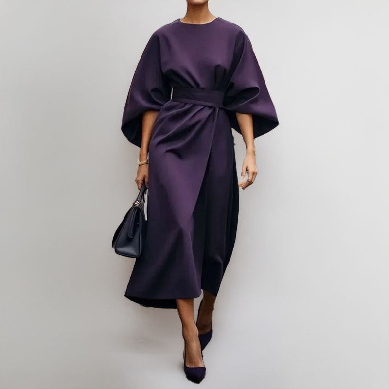 Female in an elegant satin-feel maxi dress with batwing sleeves on a clean background.