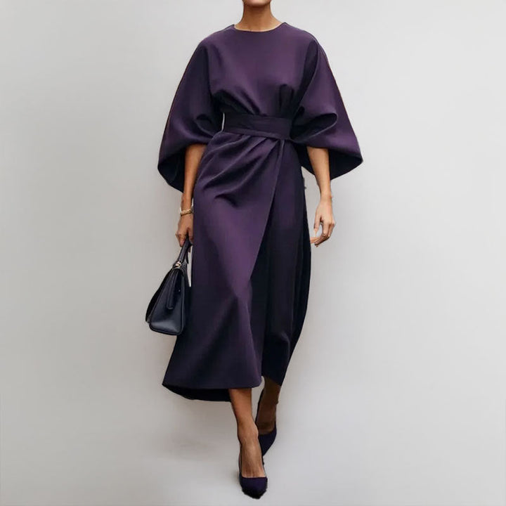Female in an elegant satin-feel maxi dress with batwing sleeves on a clean background.