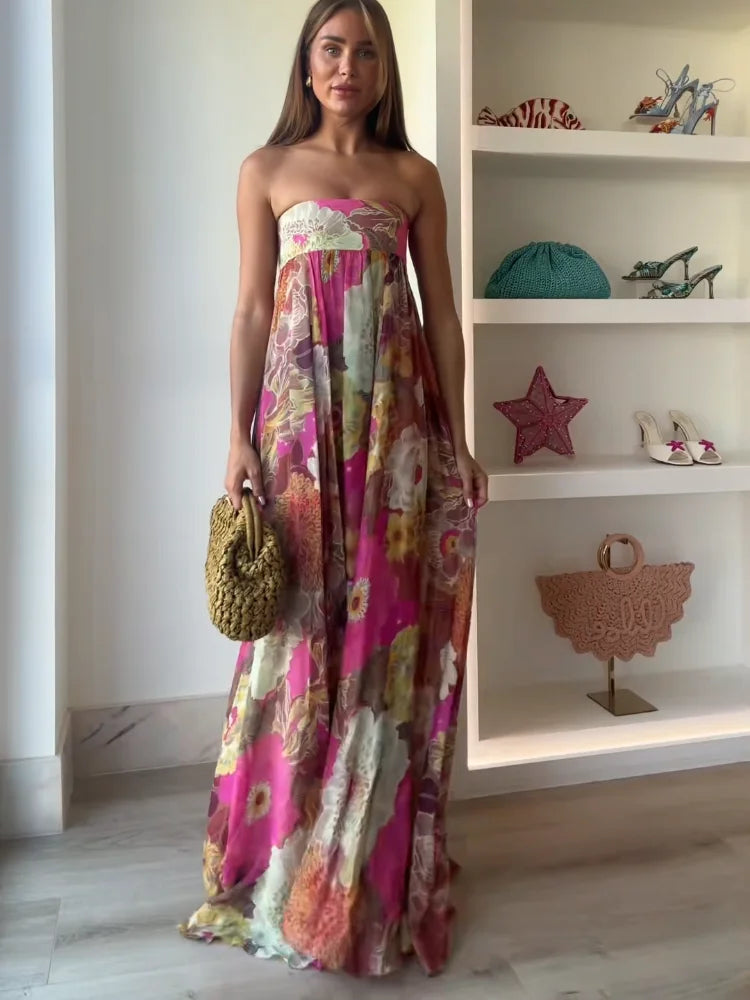 Woman wearing floral strapless maxi dress on plain background front view.
