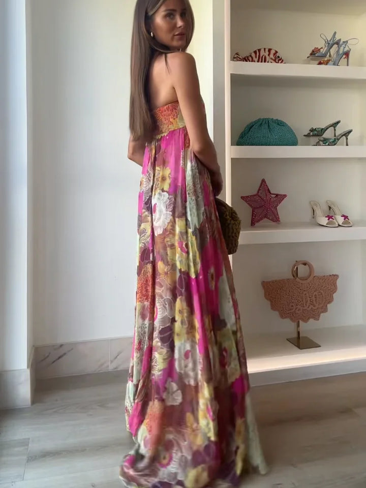 Woman posing in strapless floral dress on plain white background, back view