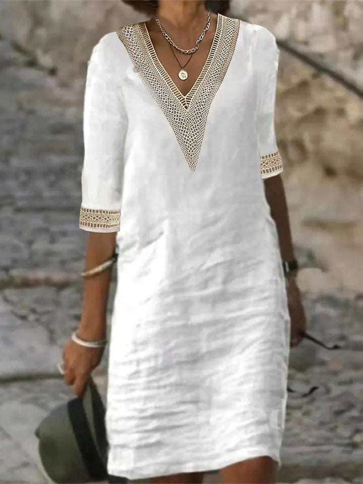 Model showcasing a women’s V-neck midi dress with lace detail and 3/4 sleeves.