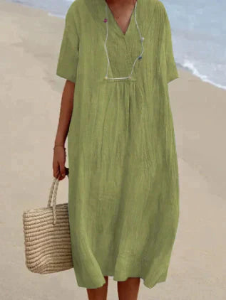 Female model in a lightweight V-neck midi dress on a clean background.