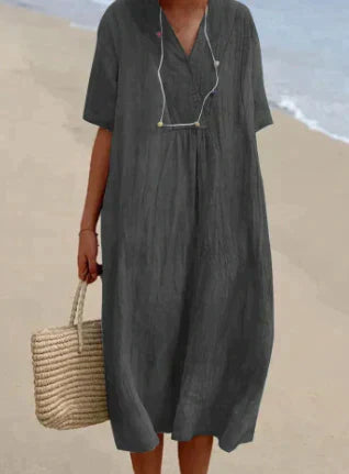 Model wearing a casual V-neck midi dress against a clean background.