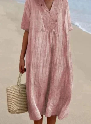 Woman showcasing a lightweight midi dress with V-neck design on a clean background.