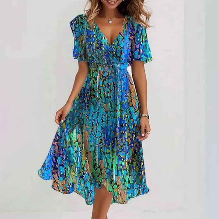 Female wearing a V-neck wrap midi dress with flutter sleeves on a plain background.