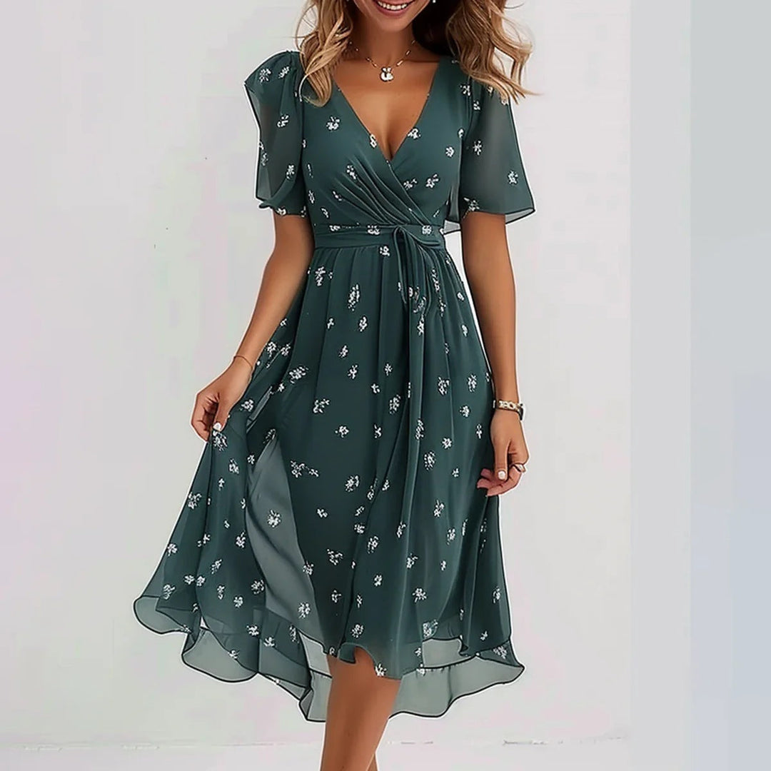 Model wearing a feminine V-neck wrap dress with short flutter sleeves on a plain background.