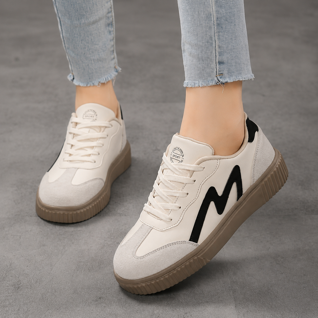 Female model wearing stylish women’s comfort shoes against a plain background.