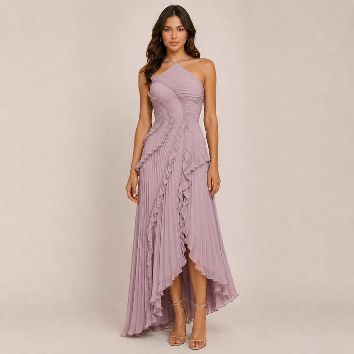 Female model wearing a flowing ruffle halter dress on a plain background.