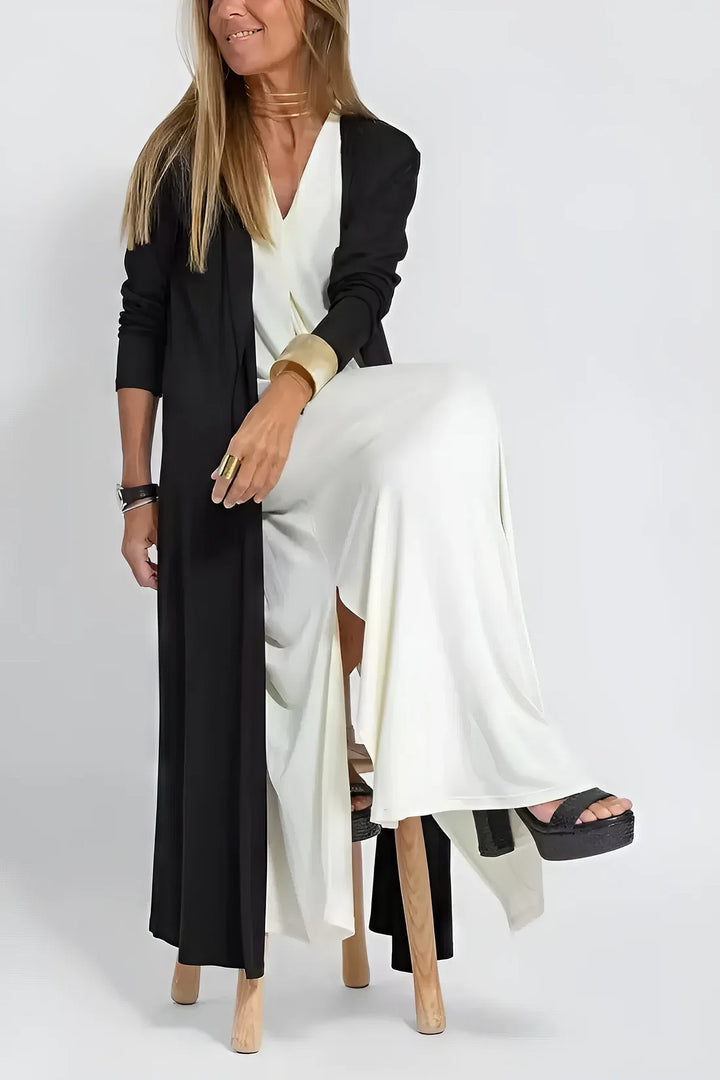 Refined long dress w/ model on a plain background, styled for elegant day-to-evening wear.