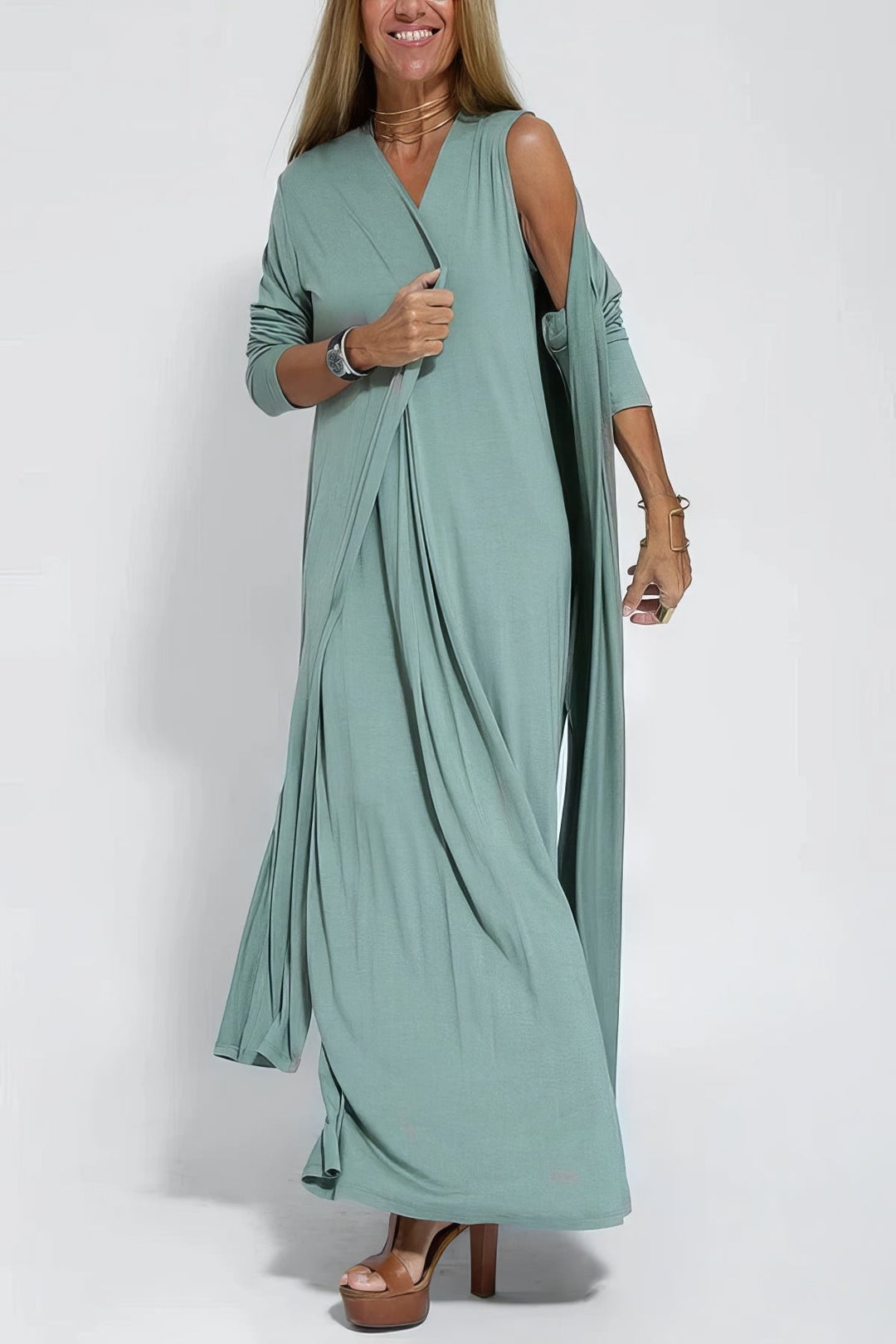 Graceful dress w/ model on a plain background, showing a smooth and elongated silhouette.