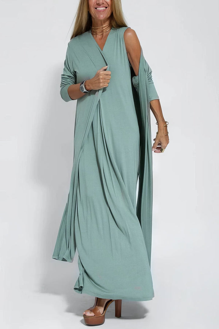 Graceful dress w/ model on a plain background, showing a smooth and elongated silhouette.
