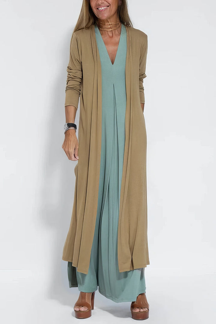 Flowing long dress w/ model on a clean background, creating a flattering balanced outline.