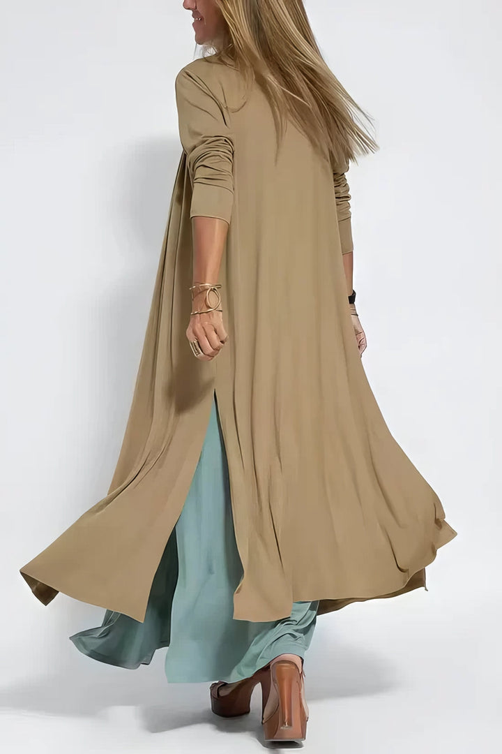 Long elegant dress w/ model on a clean background, made to flatter with gentle movement., back angle